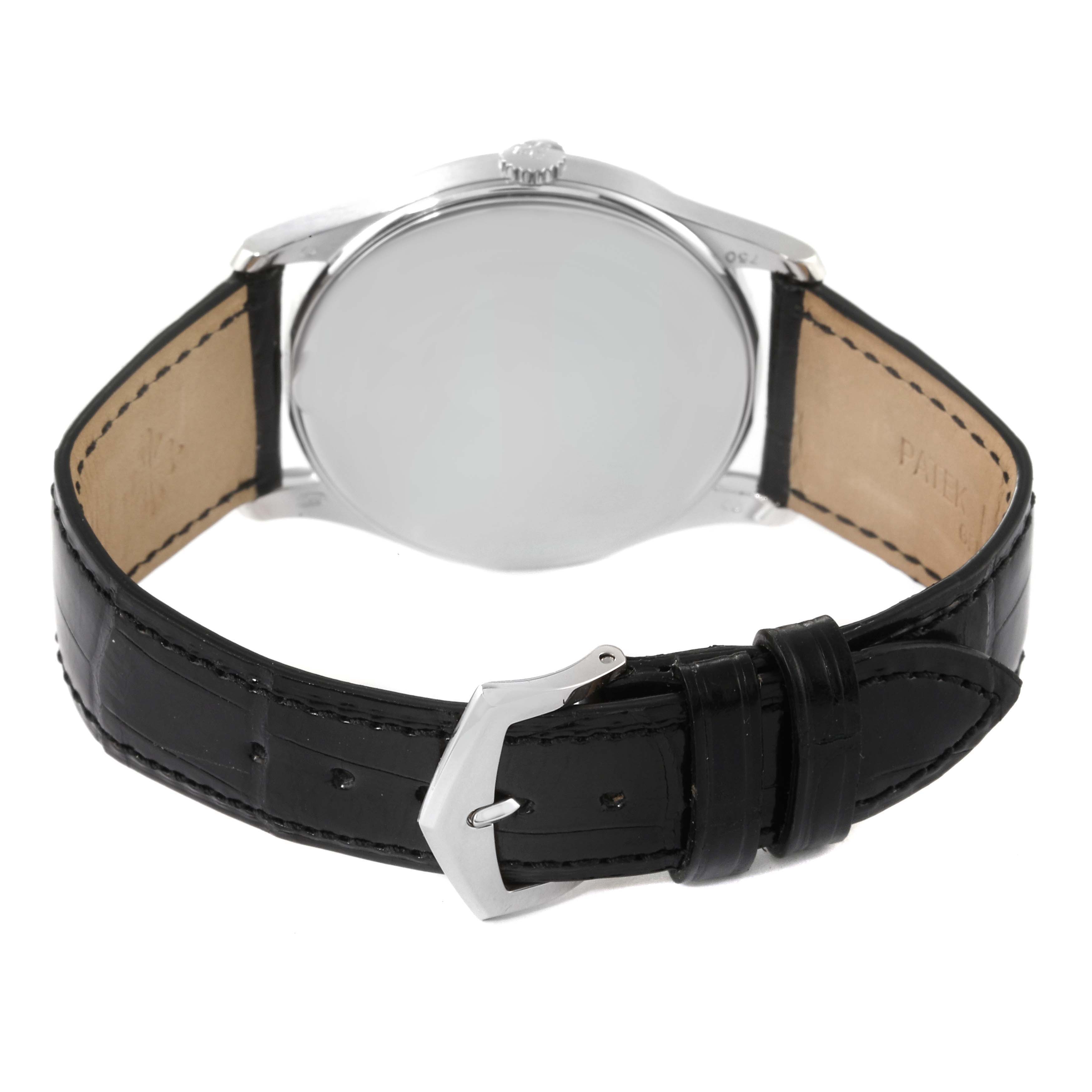 The image shows the back view of a Patek Philippe Calatrava 5196G Men's White Gold Silver Dial 5196G Men's White Gold Silver Dial watch with its black leather strap and silver buckle visible.