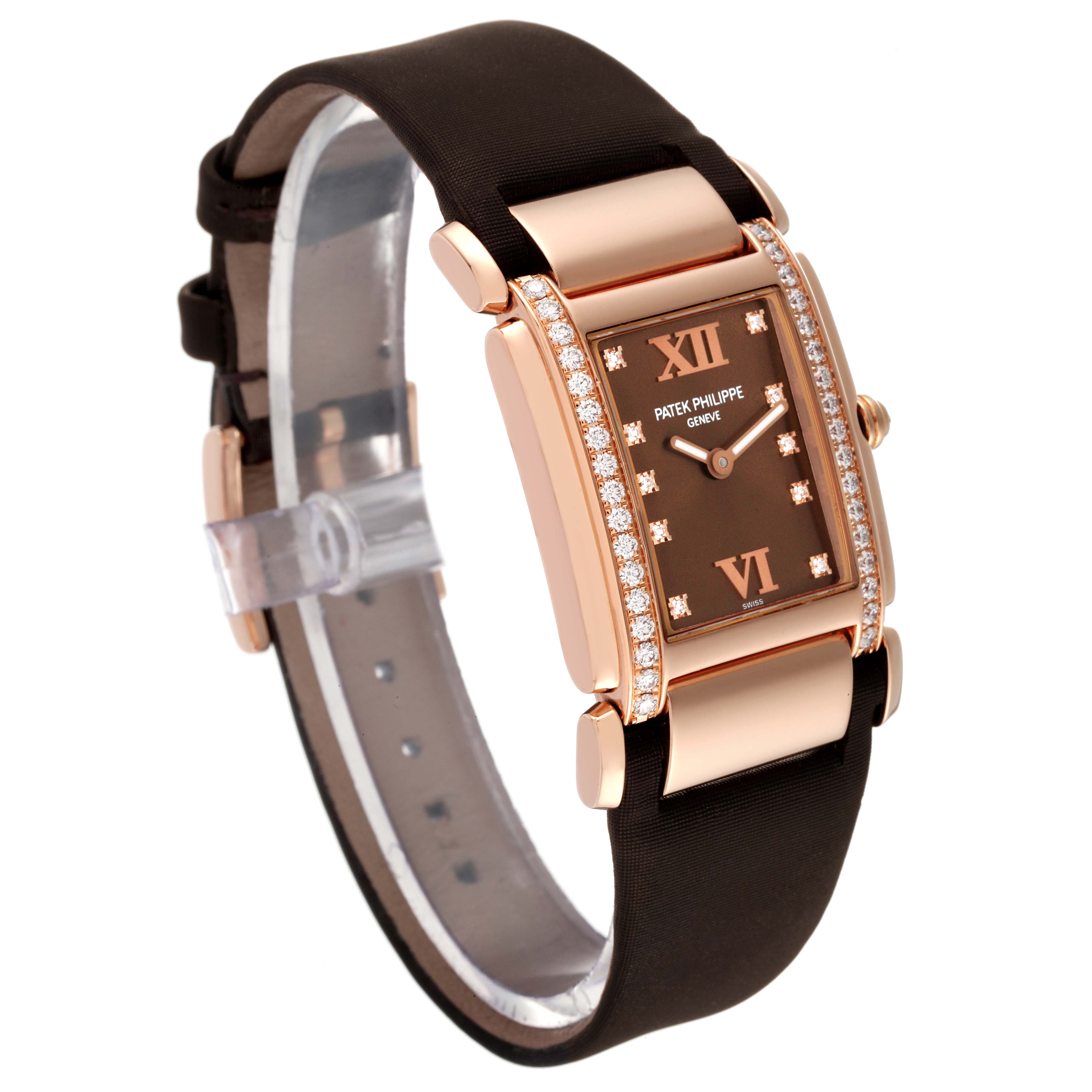 The Patek Philippe Twenty-4 4920R-10 Women's Rose Gold Brown Dial 4920R-10 Women's Rose Gold Brown Dial watch is shown at an oblique angle showcasing its rose gold case, diamond-set bezel, and black strap.