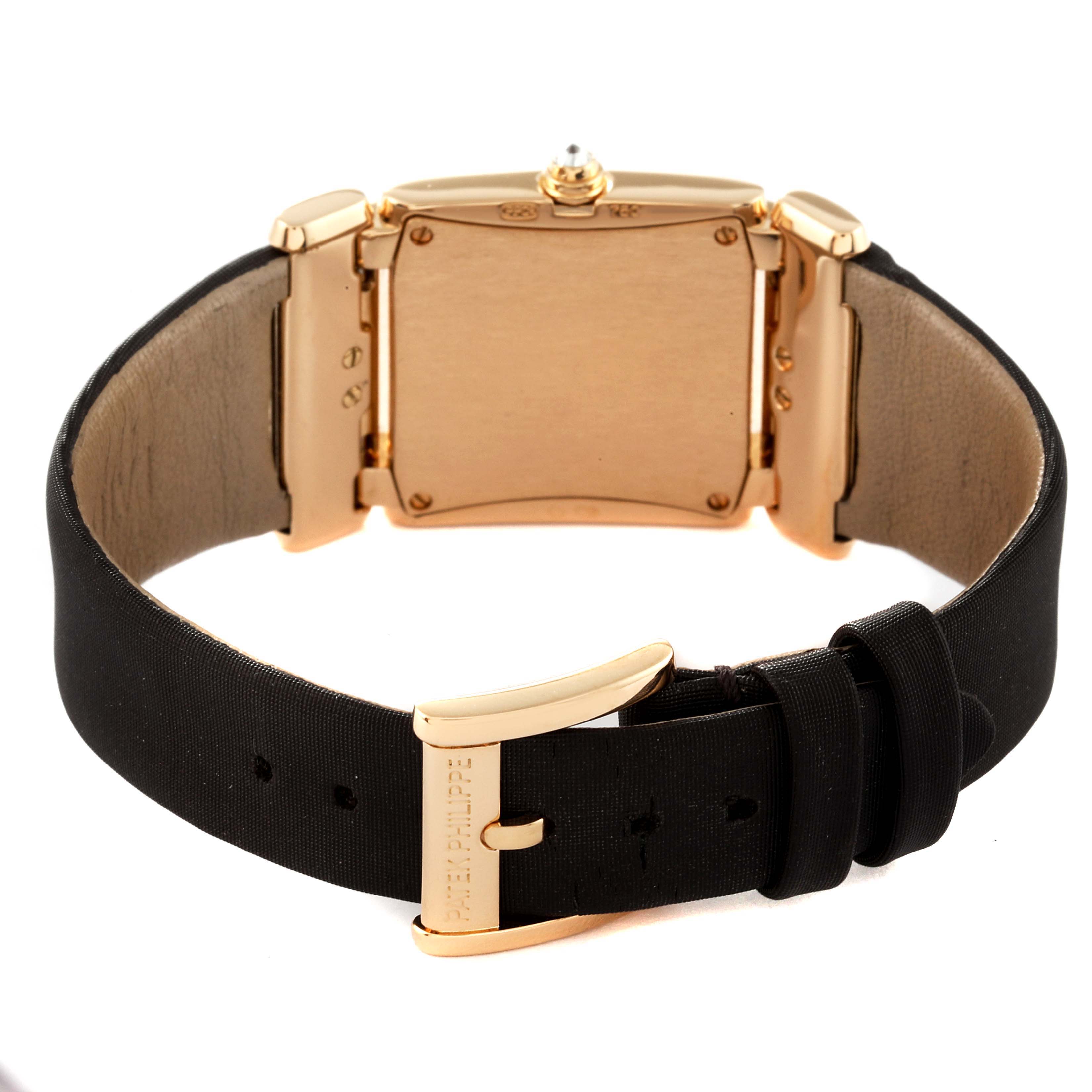 The image shows the back and clasp of a Patek Philippe Twenty-4 4920R-10 Women's Rose Gold Brown Dial 4920R-10 Women's Rose Gold Brown Dial model watch with a black strap.