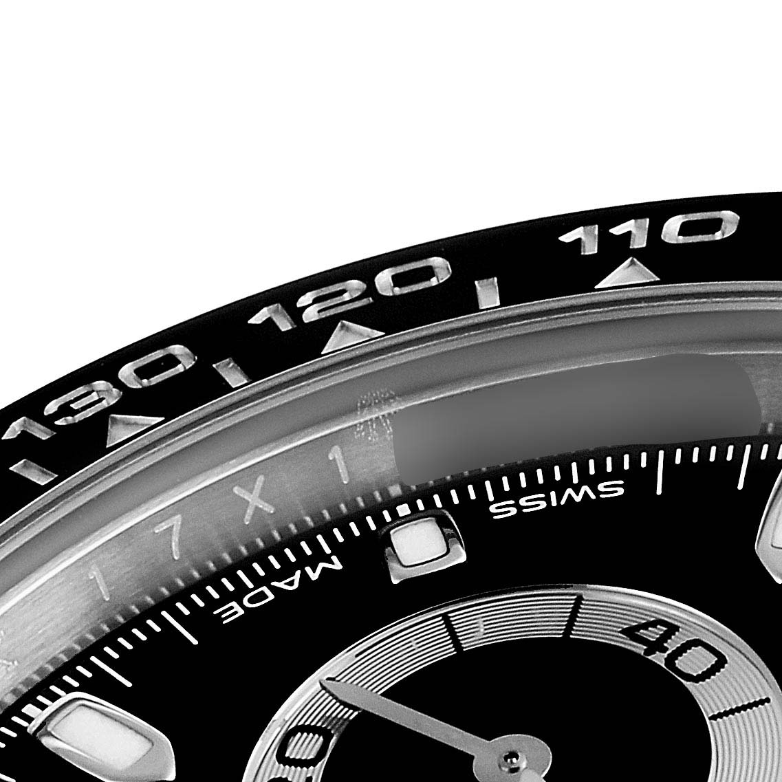 The image shows a close-up angle of the bezel and part of the dial of a Rolex Daytona 116500 Men
s Stainless Steel Black Dial 116500 Men
s Stainless Steel Black Dial watch.