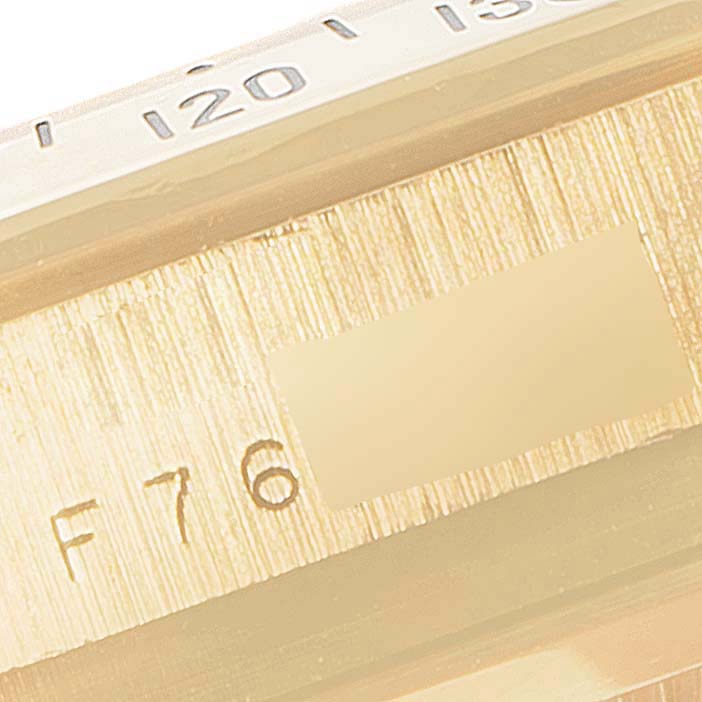 The image shows a close-up of the side of the casing and bezel with engraved details of a Rolex Daytona 116528 Men's Yellow Gold Black Dial 116528 Men's Yellow Gold Black Dial watch.