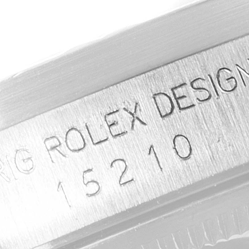 This close-up image shows the engraved model number and "Rolex Design" text on the Air-King watch case by Rolex.