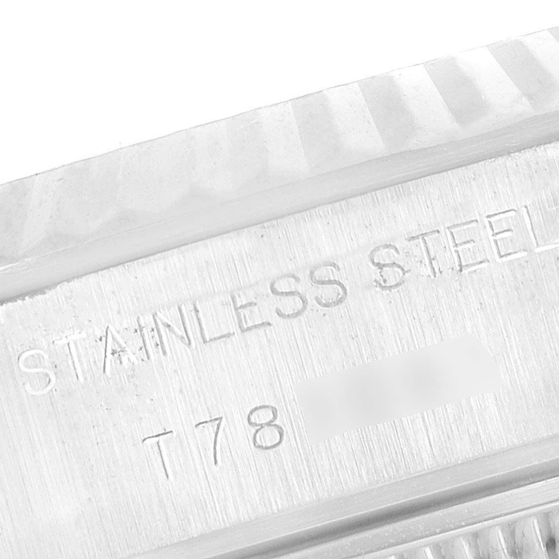 The image shows a close-up view of the Rolex Datejust 69174 Women's Stainless Steel White Dial 69174 Women's Stainless Steel White Dial model, highlighting the engraved stainless steel and serial number on the case.