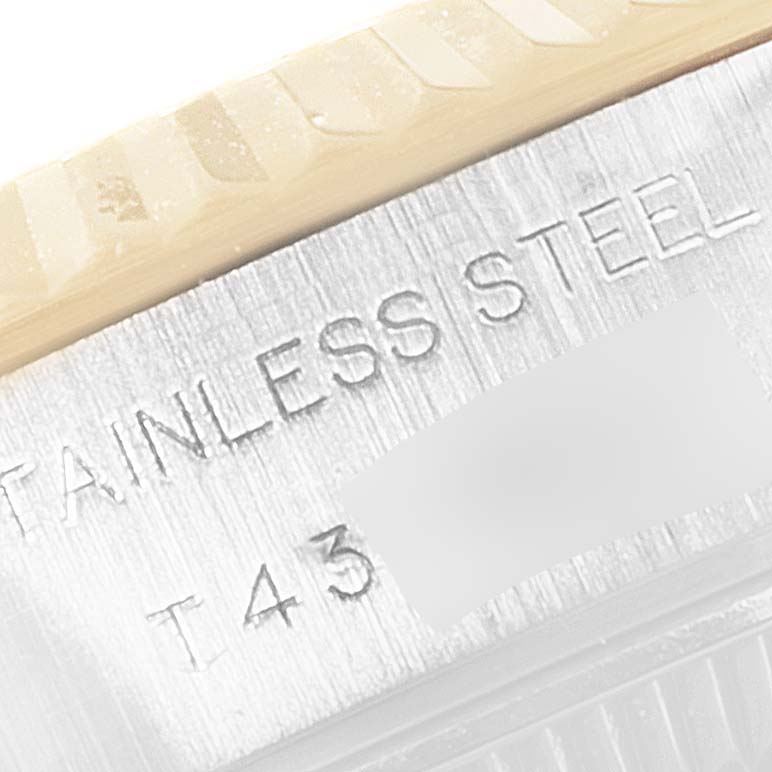 The image shows a close-up of the side of the Rolex Datejust 69173 Women
s Steel and Gold (two tone) Champagne Dial 69173 Women
s Steel and Gold (two tone) Champagne Dial watch, highlighting the stainless steel engraving and part of the bezel.