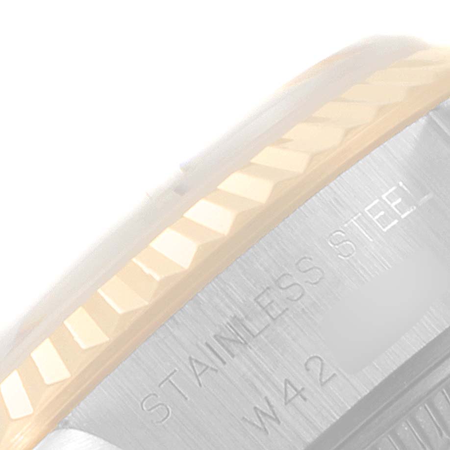 The image shows a partial view of the bezel and case side of a Rolex Datejust 40895 Women
s Steel and Gold (two tone) Champagne Dial 40895 Women
s Steel and Gold (two tone) Champagne Dial, highlighting the fluted bezel and stainless steel engraving.