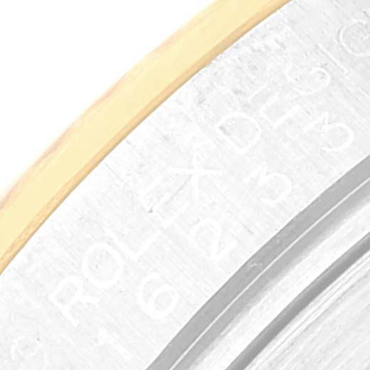 This image shows a close-up of the edge and part of the engraved rehaut of a Rolex Datejust 116233 Men's Steel and Gold (two tone) Champagne Dial 116233 Men's Steel and Gold (two tone) Champagne Dial watch.