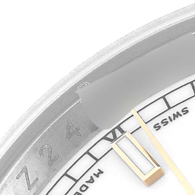 This close-up image shows the partially obscured dial and minute markers of a Rolex Datejust 116233 Men's Steel and Gold (two tone) White Dial 116233 Men's Steel and Gold (two tone) White Dial watch.