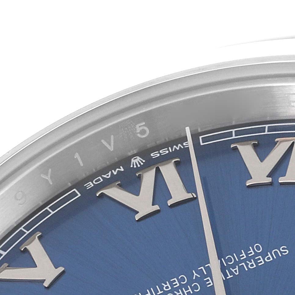 The image shows a close-up angle of the dial and part of the bezel of a Rolex Datejust 41 126300 Men
s Stainless Steel Blue Dial 126300 Men
s Stainless Steel Blue Dial watch, highlighting Roman numerals and the minute markers.