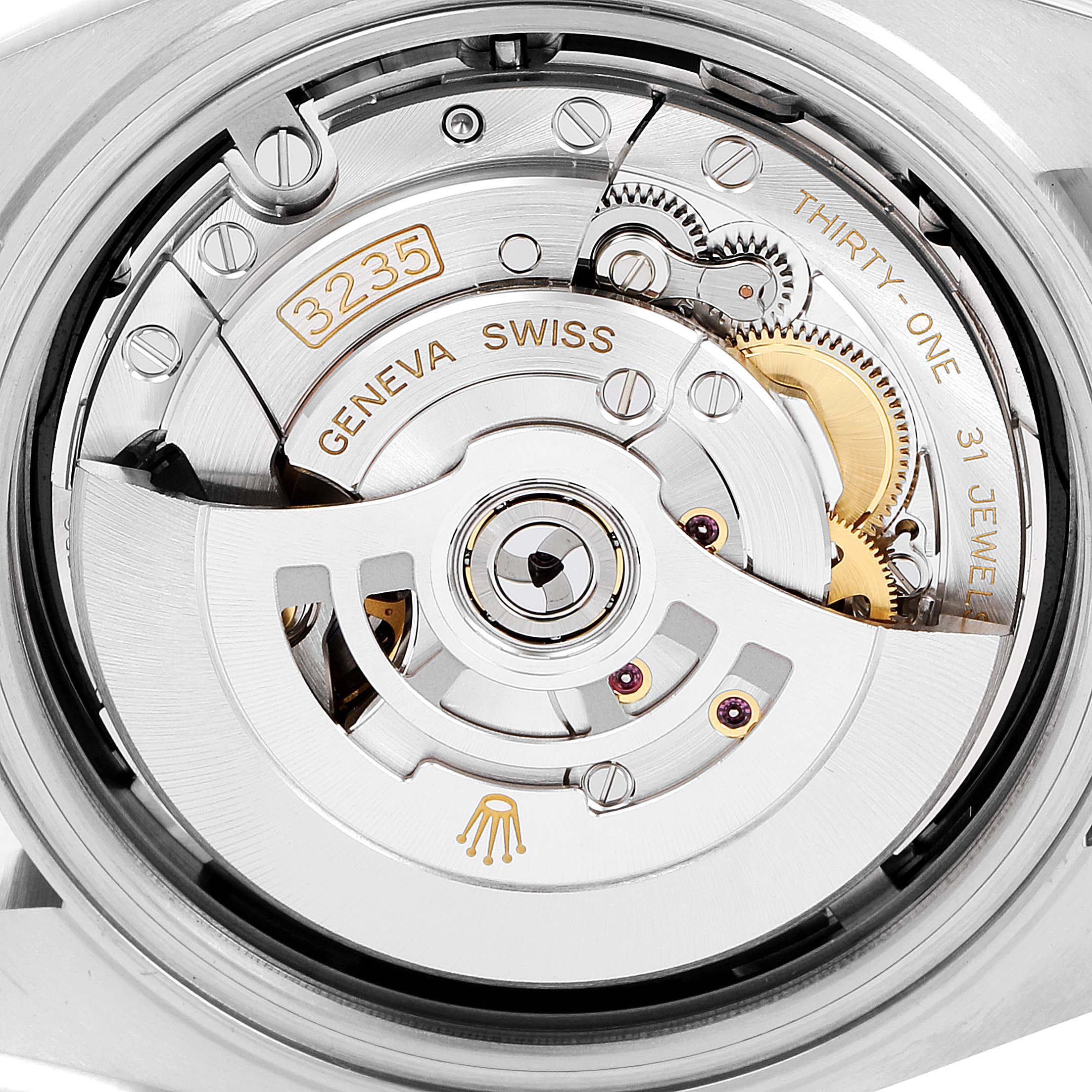 This image shows a close-up of the movement mechanism of a Rolex Datejust 41 126303 Men's Steel and Gold (two tone) Black Dial 126303 Men's Steel and Gold (two tone) Black Dial watch, revealing internal components and engravings.