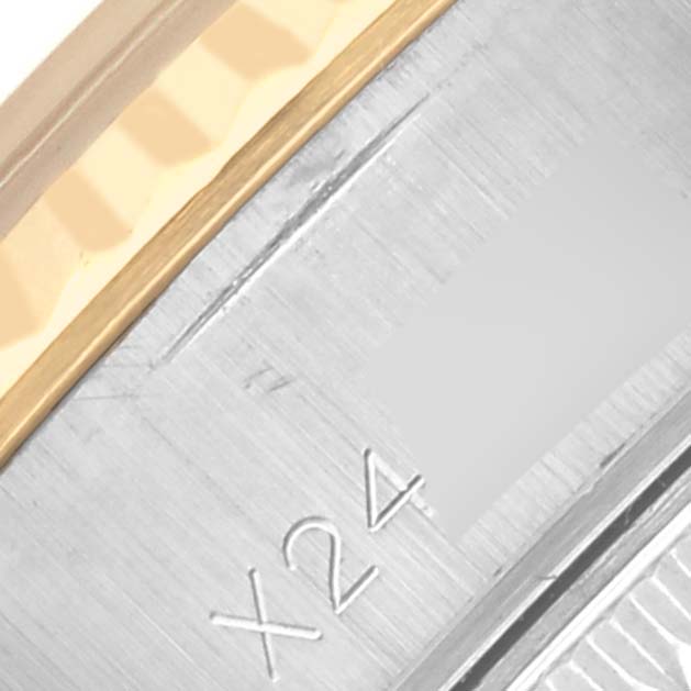 The image shows a close-up of the side of a Rolex Datejust 69173 Women's Steel and Gold (two tone) Blue Dial 69173 Women's Steel and Gold (two tone) Blue Dial watch, highlighting part of the bezel and metal surface with engraved markings.