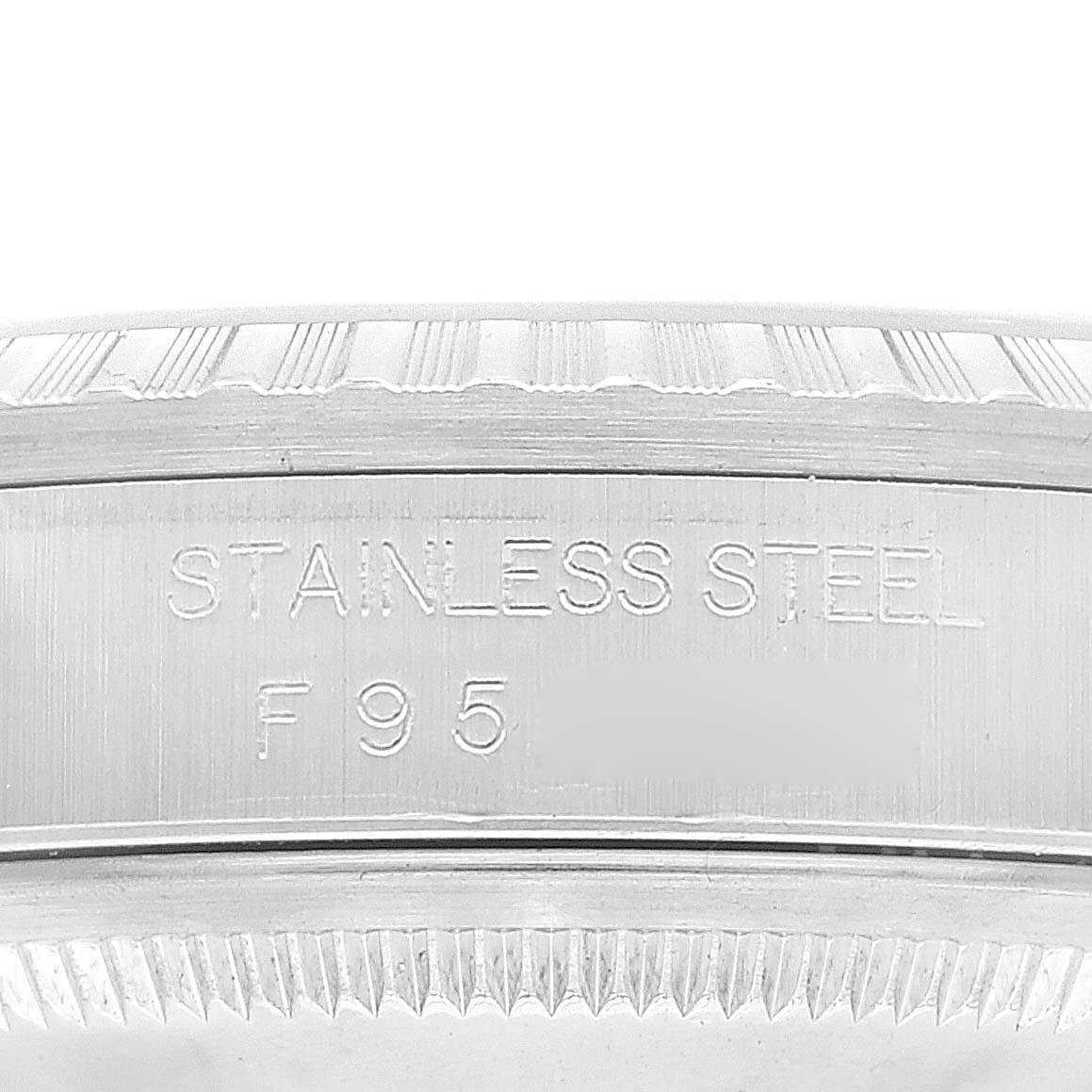 This image shows a close-up of the stainless steel case back of a Rolex Datejust 16220 Men's Stainless Steel Silver Dial 16220 Men's Stainless Steel Silver Dial watch with engraved markings.