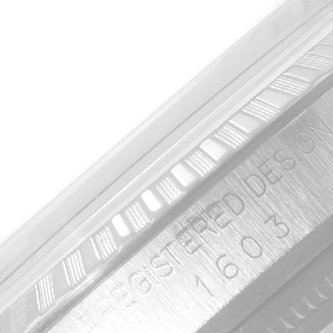 The image shows a close-up angle of the bezel and the rehaut with engraved model details of the Rolex Datejust 1603 Men
s Stainless Steel Silver Dial 1603 Men
s Stainless Steel Silver Dial watch.