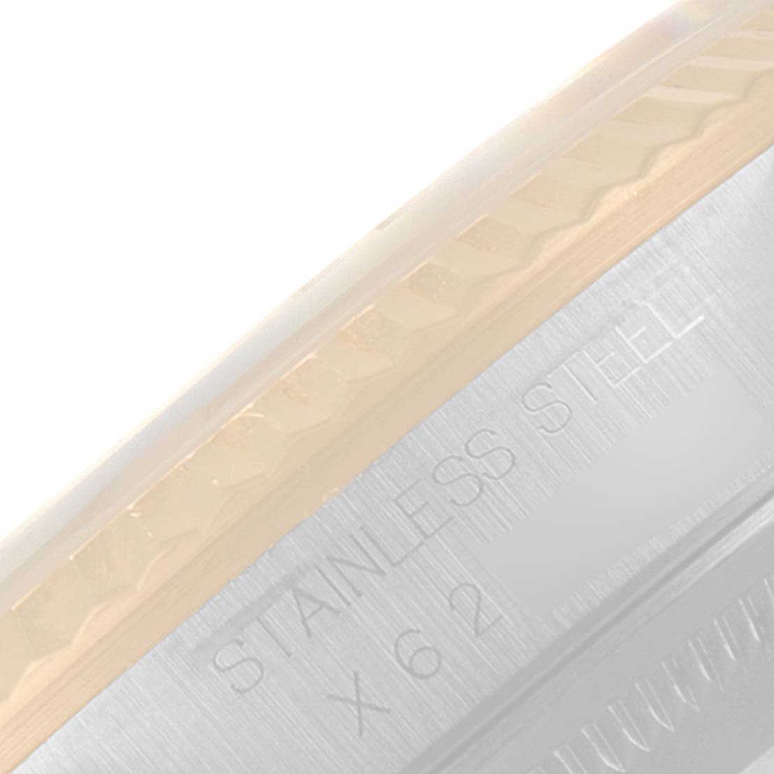 This close-up image shows a part of the stainless steel case-back edge and fluted bezel of the Rolex Datejust 16233 Men's Steel and Gold (two tone) Champagne Dial 16233 Men's Steel and Gold (two tone) Champagne Dial watch.