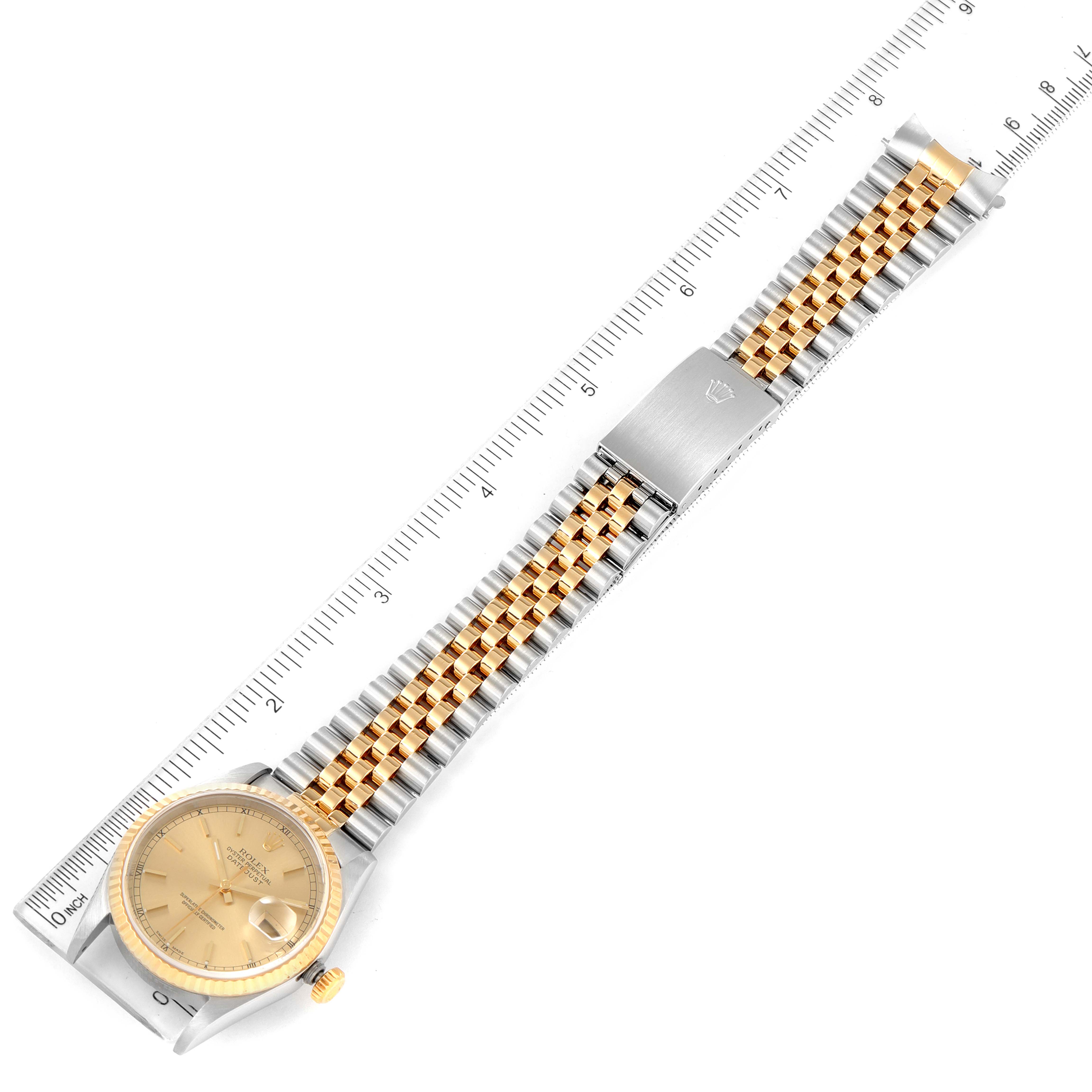 The image shows a Rolex Datejust 16233 Men's Steel and Gold (two tone) Champagne Dial 16233 Men's Steel and Gold (two tone) Champagne Dial watch laid flat with its bracelet extended, accompanied by a ruler for scale.