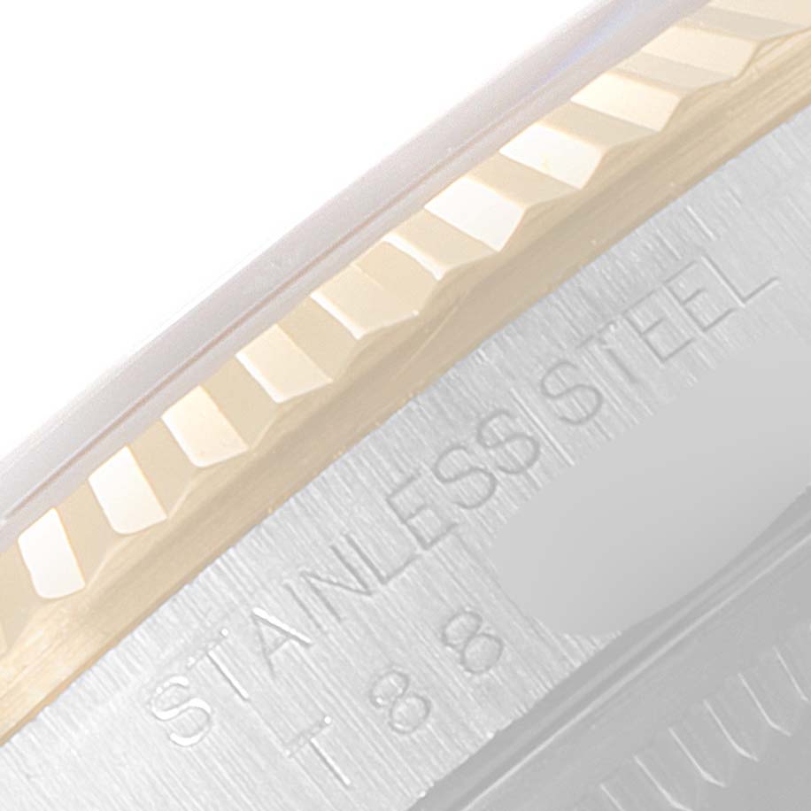 This close-up image shows the side edge, including the fluted bezel, and part of the case with "STAINLESS STEEL" engraving on the Rolex Datejust 16233 Men's Steel and Gold (two tone) Champagne Dial 16233 Men's Steel and Gold (two tone) Champagne Dial.