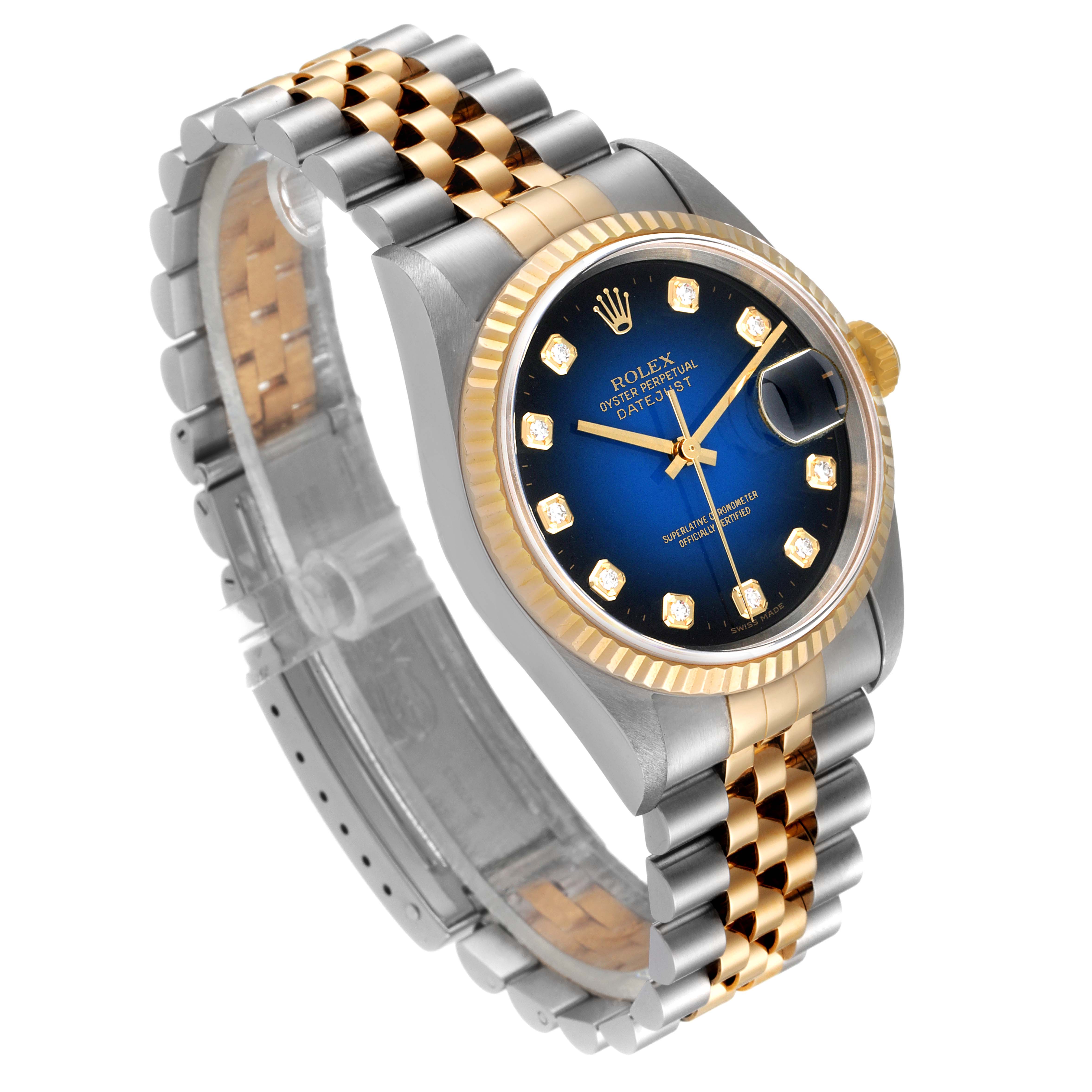 This image shows a Rolex Datejust 16233 Men's Steel and Gold (two tone) Blue Dial 16233 Men's Steel and Gold (two tone) Blue Dial watch angled to display the blue dial, fluted bezel, and two-tone bracelet.