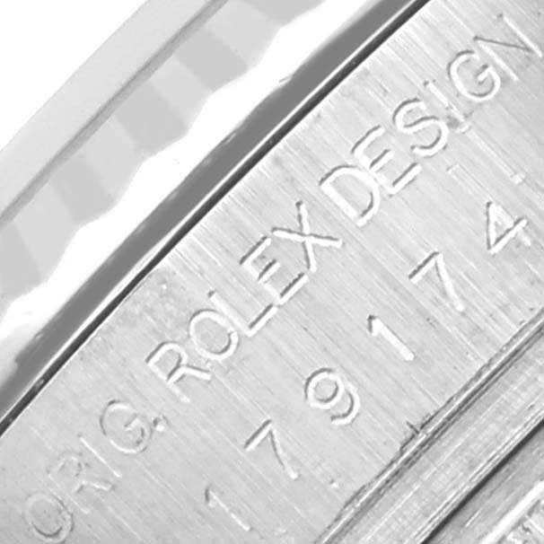 The close-up image shows the engraved side of the case of a Rolex Datejust 179174 Women's Stainless Steel Silver Dial 179174 Women's Stainless Steel Silver Dial watch.