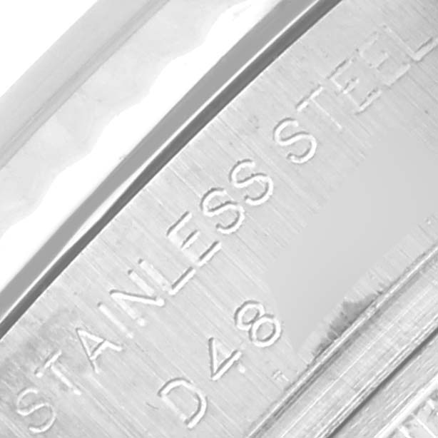 The image shows a close-up of the stainless steel Rolex Datejust 179174 Women's Stainless Steel Silver Dial 179174 Women's Stainless Steel Silver Dial watch case with engraved text.