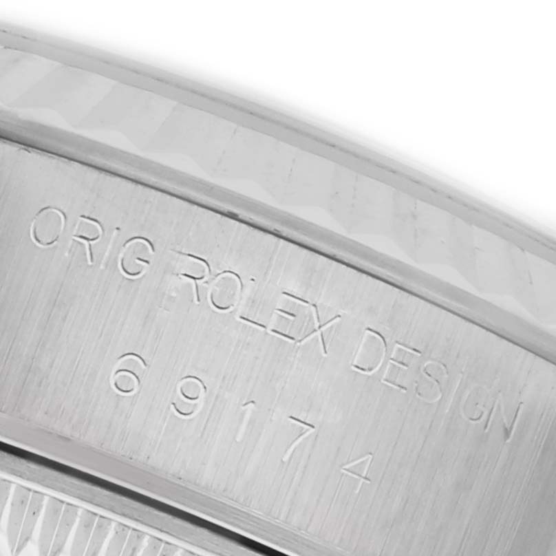 The image shows the side engraving on the case of a Rolex Datejust 69174 Women's Stainless Steel Silver Dial 69174 Women's Stainless Steel Silver Dial, highlighting the serial and design numbers.