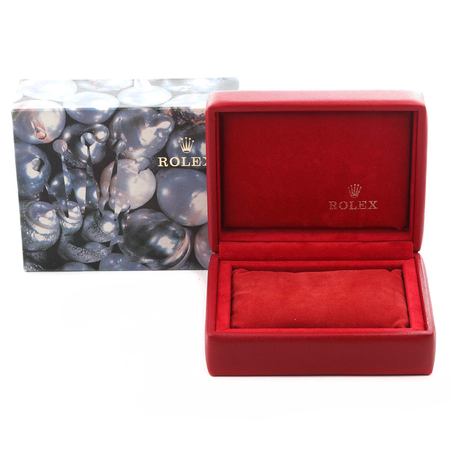 The image shows a red Rolex Datejust 69174 Women's Stainless Steel Silver Dial 69174 Women's Stainless Steel Silver Dial watch box, open, with a branded cushion inside and a decorative outer box nearby.