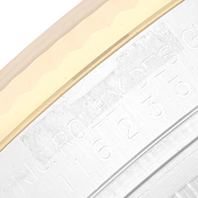 This image shows a close-up angle of the Rolex Datejust 116233 Men's Steel and Gold (two tone) Black Dial 116233 Men's Steel and Gold (two tone) Black Dial watch, focusing on the edge of the bezel and part of the engraved case.