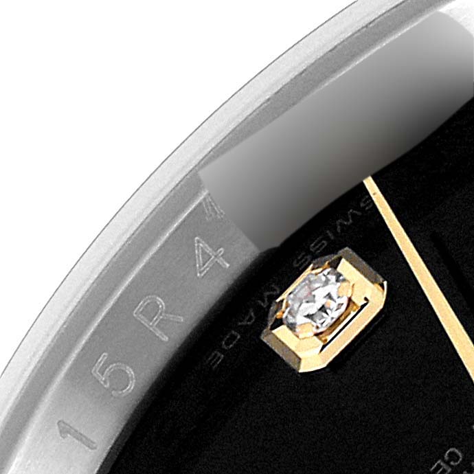 This close-up image of the Rolex Datejust 116233 Men's Steel and Gold (two tone) Black Dial 116233 Men's Steel and Gold (two tone) Black Dial shows the bezel, part of the dial, and a diamond hour marker.