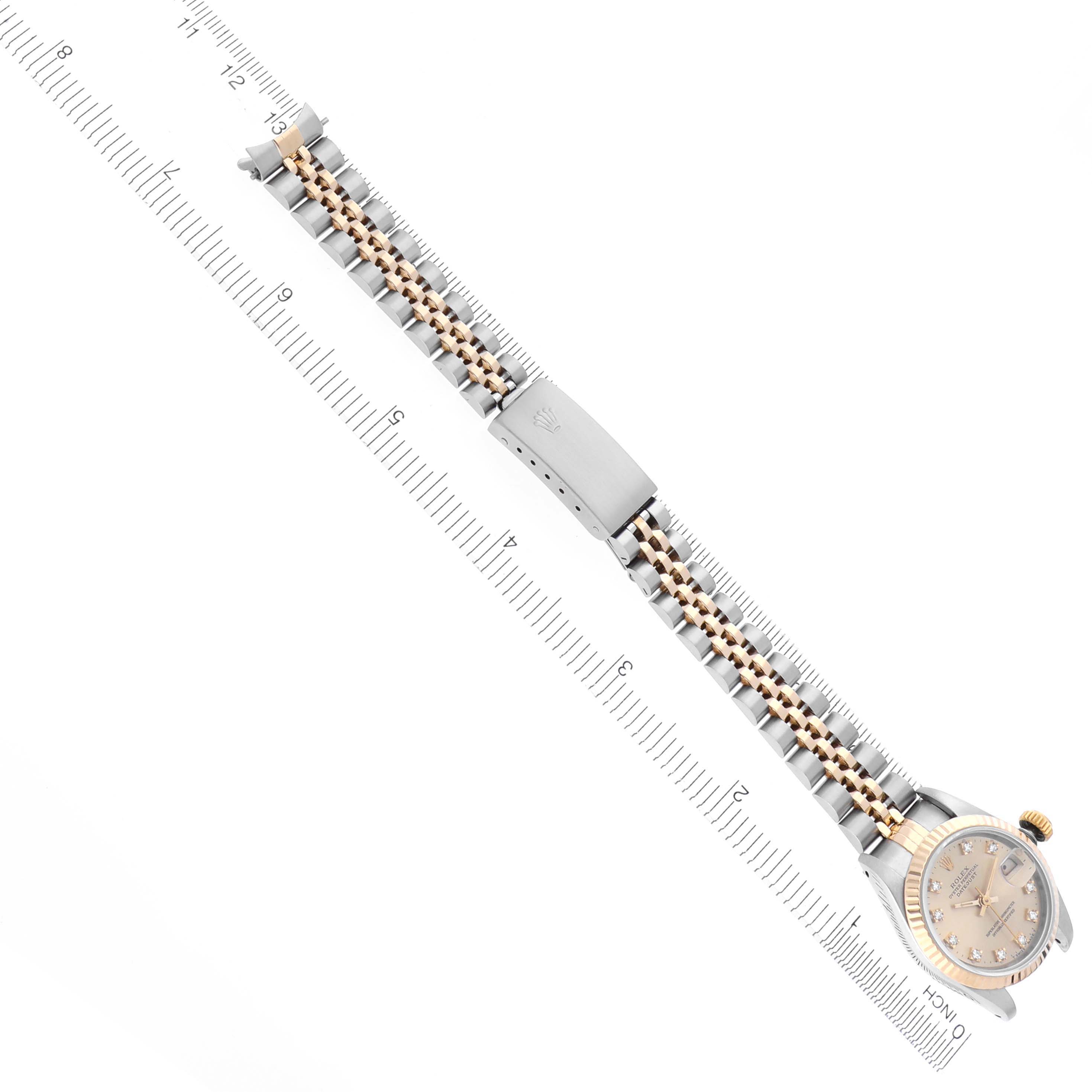 The image shows a Rolex Datejust 69173 Women's Steel and Gold (two tone) Champagne Dial 69173 Women's Steel and Gold (two tone) Champagne Dial watch from an overhead angle, focusing on the bracelet and clasp, with a ruler for scale.