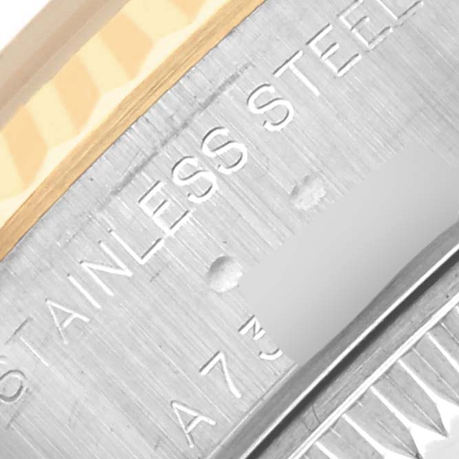 The image shows a close-up of a Rolex Datejust 79173 Women's Steel and Gold (two tone) Champagne Dial 79173 Women's Steel and Gold (two tone) Champagne Dial watch case, highlighting the stainless steel part and part of the bezel.