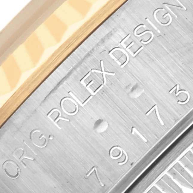 The image shows a close-up of the side engraving on a Rolex Datejust 79173 Women's Steel and Gold (two tone) Champagne Dial 79173 Women's Steel and Gold (two tone) Champagne Dial watch, highlighting the brand and design details.