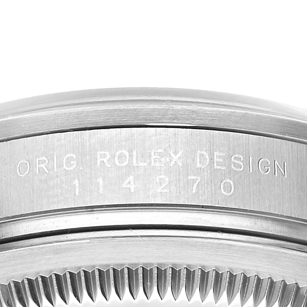 This image shows a close-up of the case side and bezel of a Rolex Explorer 114270 Men
s Stainless Steel Black Dial 114270 Men
s Stainless Steel Black Dial model watch, displaying its engraved serial number.