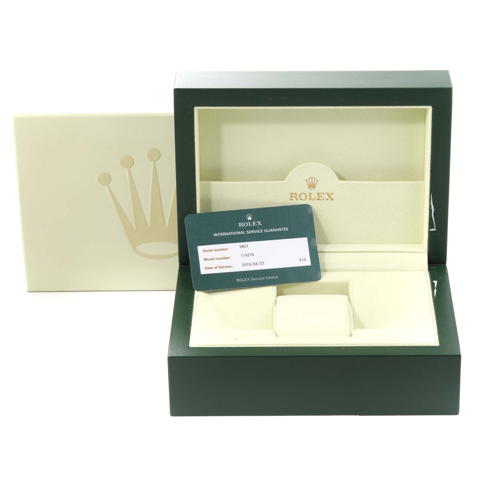 The image shows an open green Rolex Explorer 114270 Men
s Stainless Steel Black Dial 114270 Men
s Stainless Steel Black Dial watch box with an International Service Guarantee card visible.