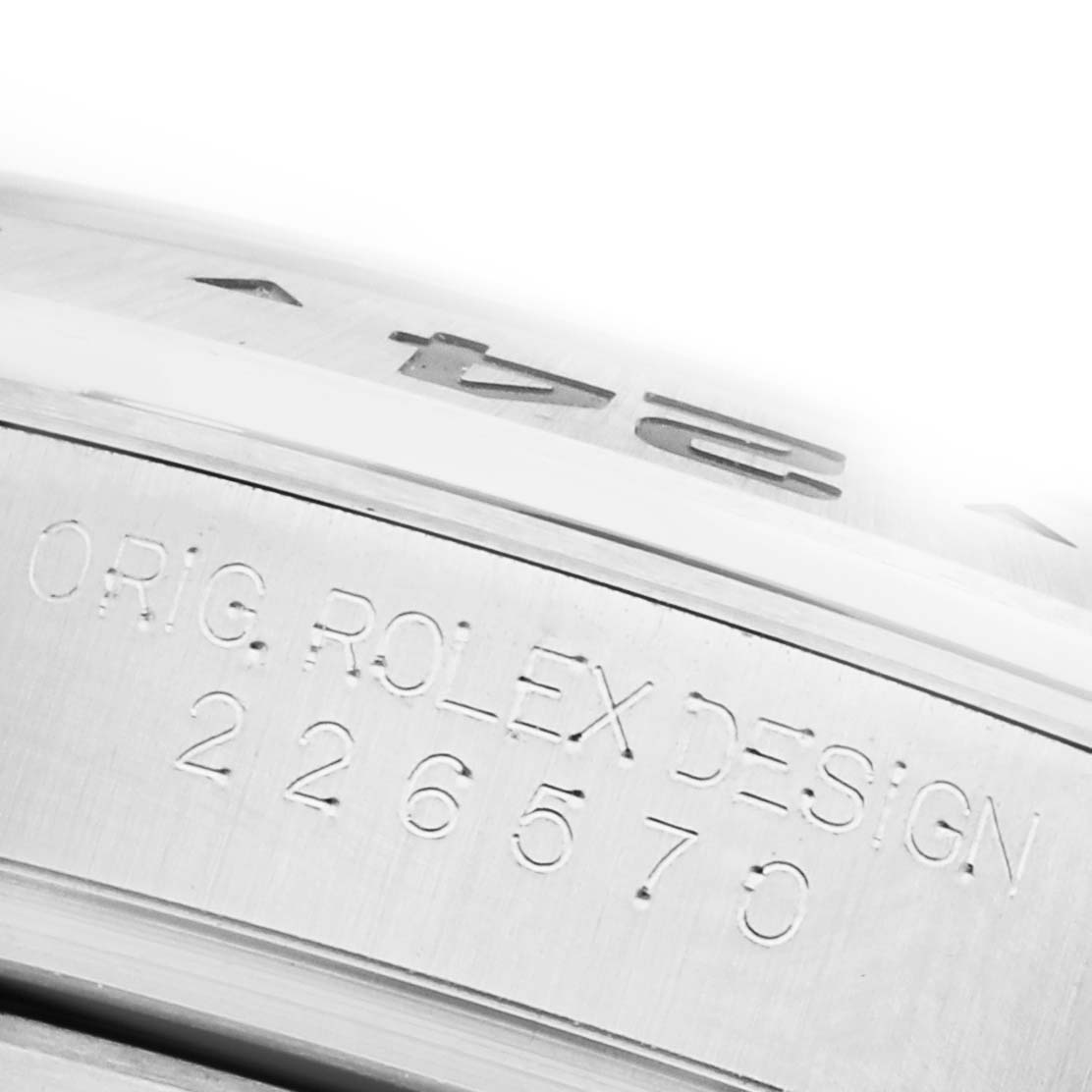 The image shows a close-up of the side of the Rolex Explorer M226570-0002 Men's Stainless Steel Black Dial M226570-0002 Men's Stainless Steel Black Dial watch, highlighting its engraved serial number and design markings.