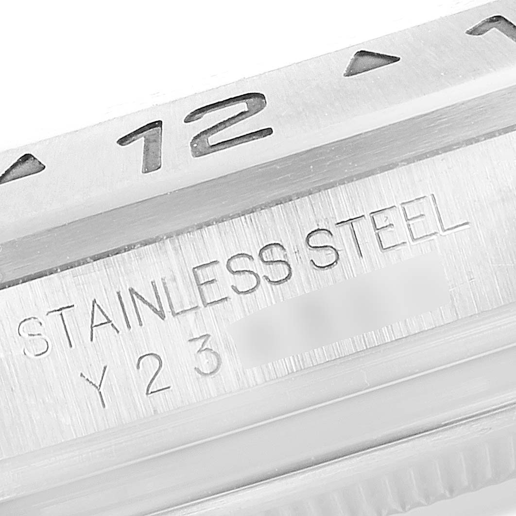 The image shows a macro shot of the engraving on a stainless steel Rolex Explorer 16570 Men's Stainless Steel Black Dial 16570 Men's Stainless Steel Black Dial watch case, highlighting the "STAINLESS STEEL" text and part of the bezel.