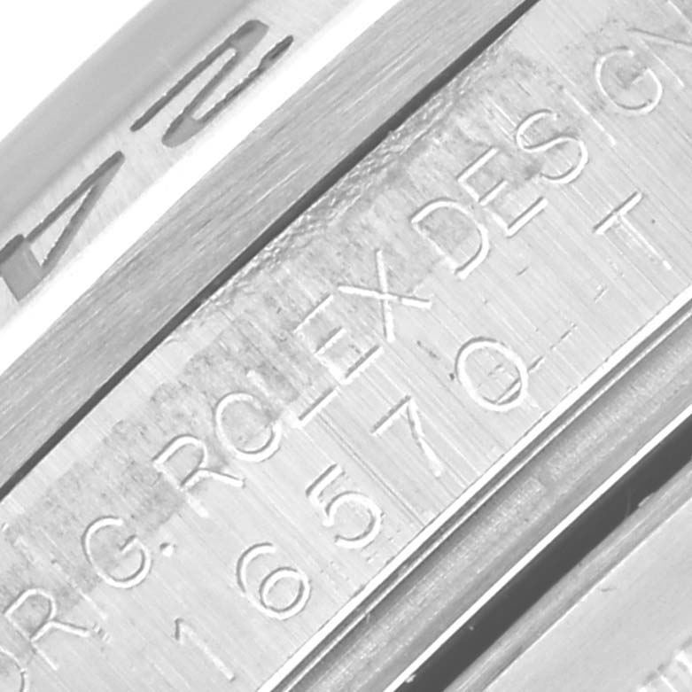 The image shows an angled close-up of the engraved side of a Rolex Explorer 16570 Men's Stainless Steel White Dial 16570 Men's Stainless Steel White Dial watch, highlighting the model number and design details.