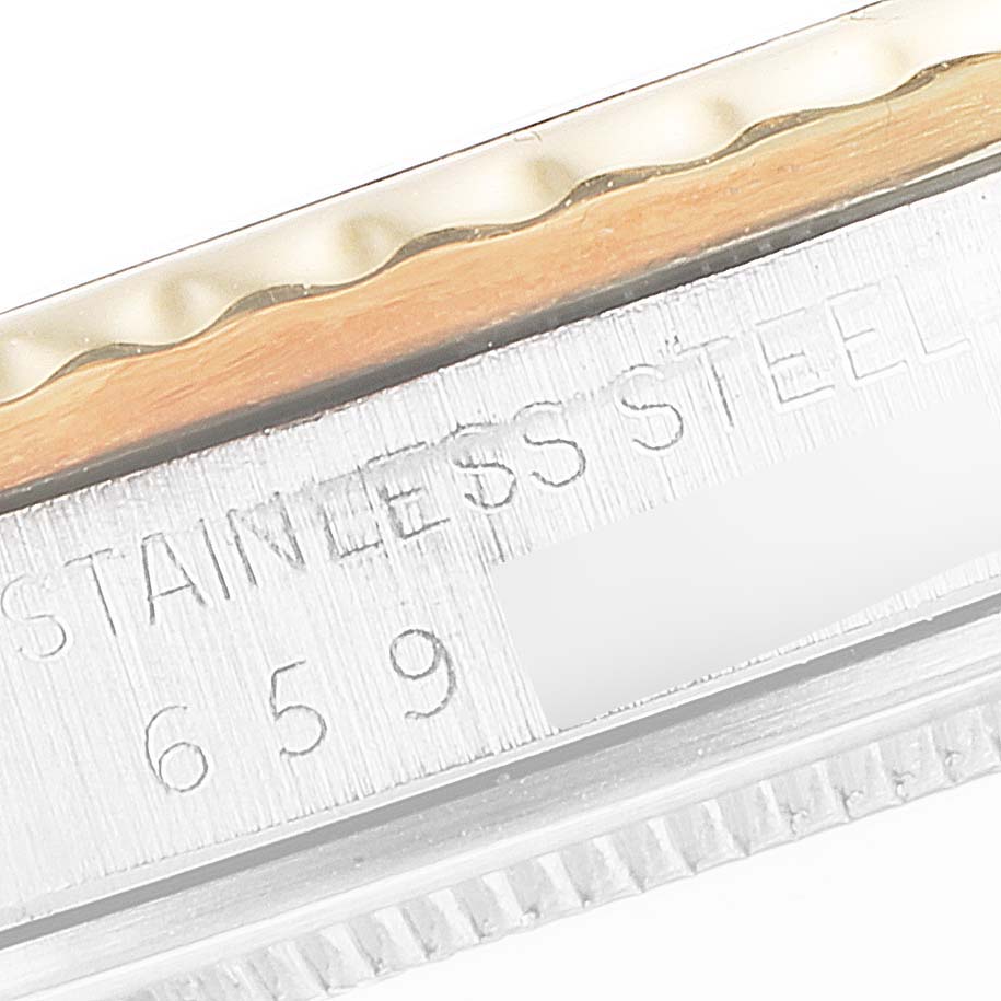 This close-up image of the Rolex Vintage Collection 16753 Men's Steel and Gold (two tone) Black Dial 16753 Men's Steel and Gold (two tone) Black Dial watch shows part of the bezel and the engraved text on the stainless steel case.