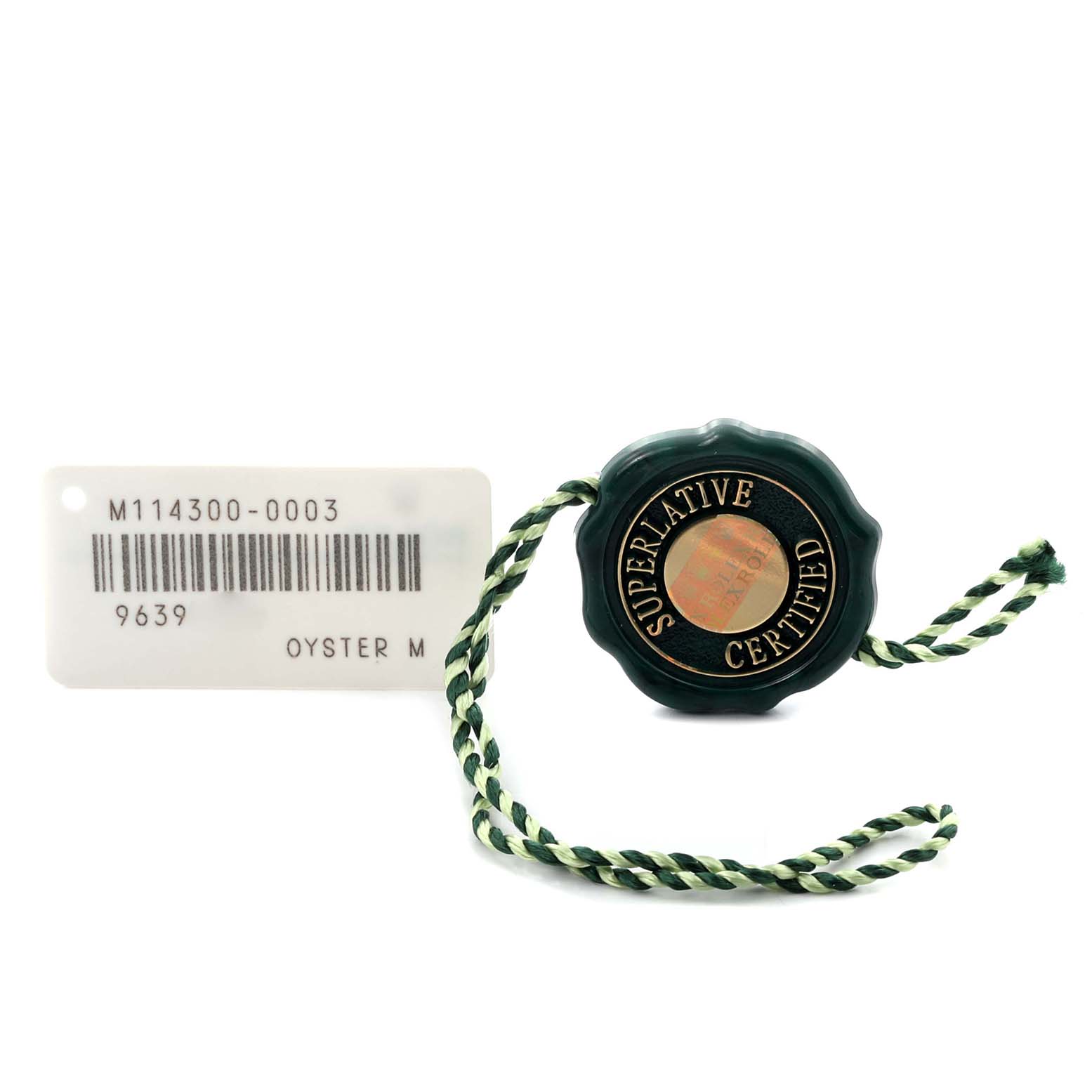 The image shows a Rolex Oyster Perpetual 114300 Men's Stainless Steel Blue Dial 114300 Men's Stainless Steel Blue Dial's hang tag and barcode tag at a top-down angle.