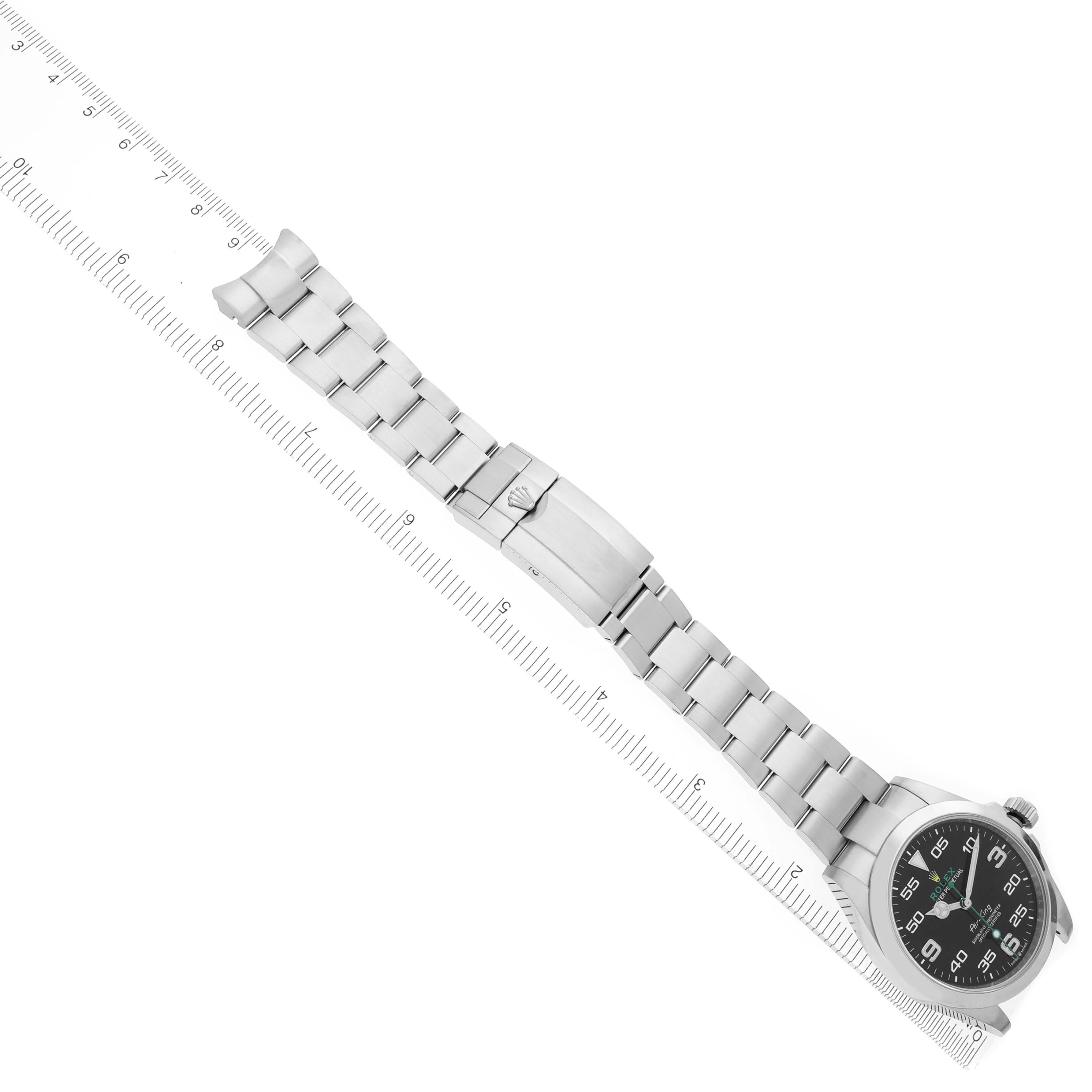 The image shows a Rolex Air-King 126900 Men's Stainless Steel Black Dial 126900 Men's Stainless Steel Black Dial watch laid diagonally with its face, bracelet, and clasp visible next to a measuring ruler.