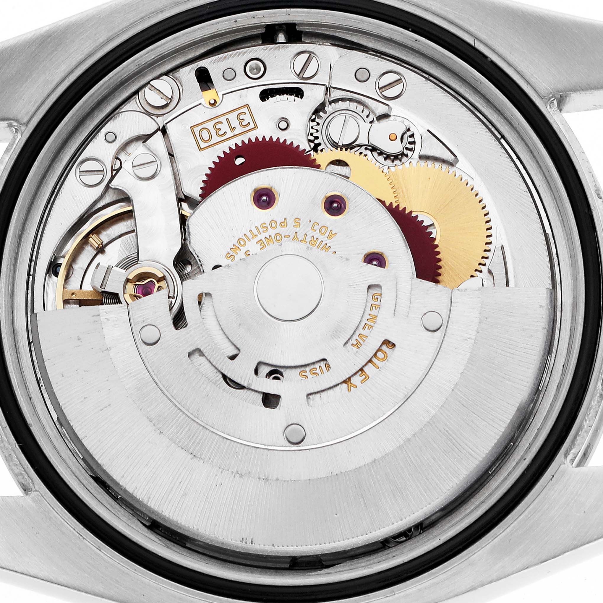 The image shows the movement of a Rolex Oyster Perpetual 116034 Men's Stainless Steel Silver Dial, highlighting gears and the oscillating rotor from the back.