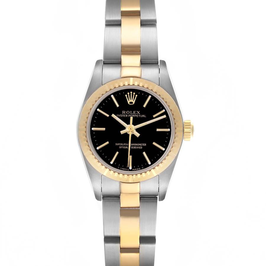 The Rolex Oyster Perpetual watch is shown from a top-down angle highlighting its black dial, gold bezel, and two-tone bracelet.
