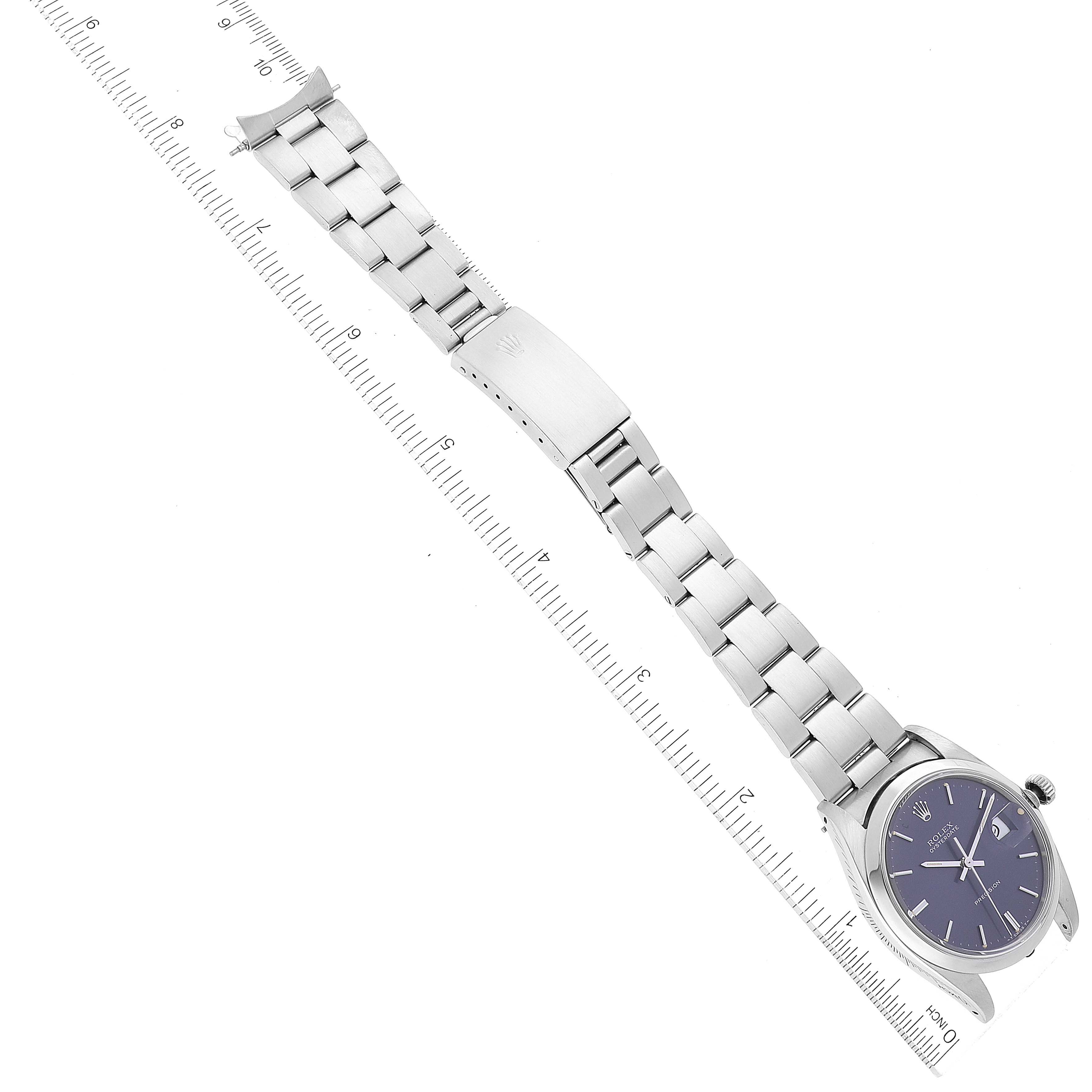 The image shows a Rolex Date 6694 Men's Stainless Steel Blue Dial 6694 Men's Stainless Steel Blue Dial watch laid flat with its metal bracelet extended, displayed alongside a ruler for size reference.