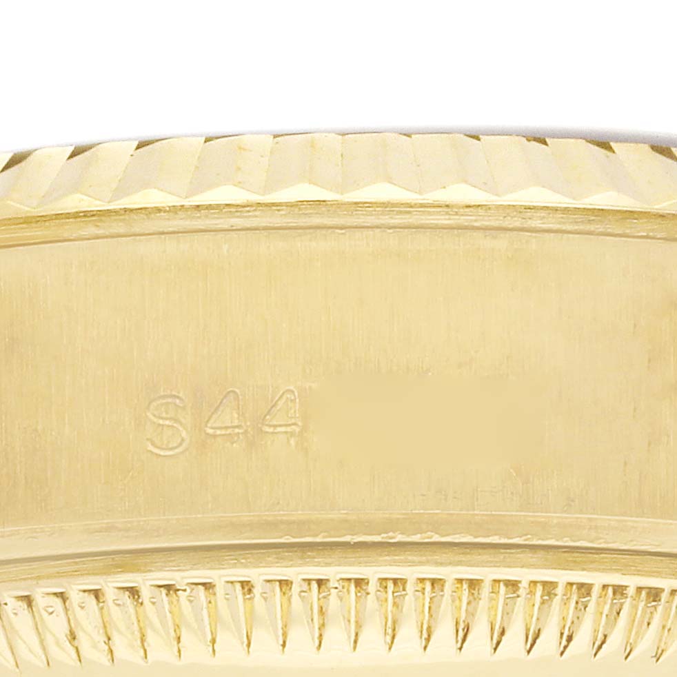 The image shows a close-up of the Rolex President 69178 Women's Yellow Gold Champagne Dial 69178 Women's Yellow Gold Champagne Dial model's bezel and case edge, highlighting the fluted design.