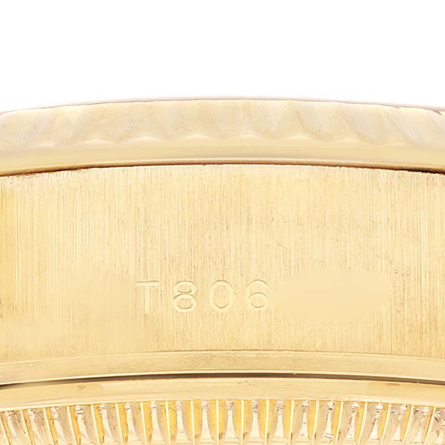 The image shows a close-up of the side of the Rolex President 69178 Women's Yellow Gold Champagne Dial 69178 Women's Yellow Gold Champagne Dial model, focusing on the bezel and part of the band.
