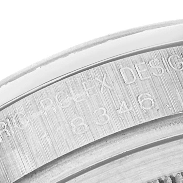 The image shows a close-up of the engraved inner bezel of the Rolex President 118346 Men's Platinum Silver Dial 118346 Men's Platinum Silver Dial model watch, displaying part of the serial number and "ROLEX DESIGN".