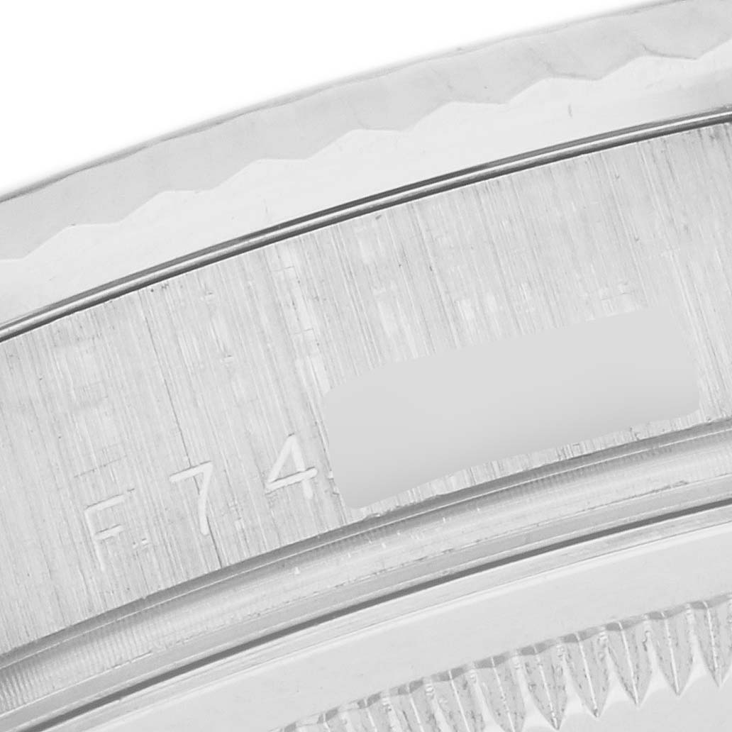 The image shows a close-up of the case back and edge of the bezel on a Rolex President 118239 Men
s White Gold White Dial 118239 Men
s White Gold White Dial watch, highlighting engraved details.