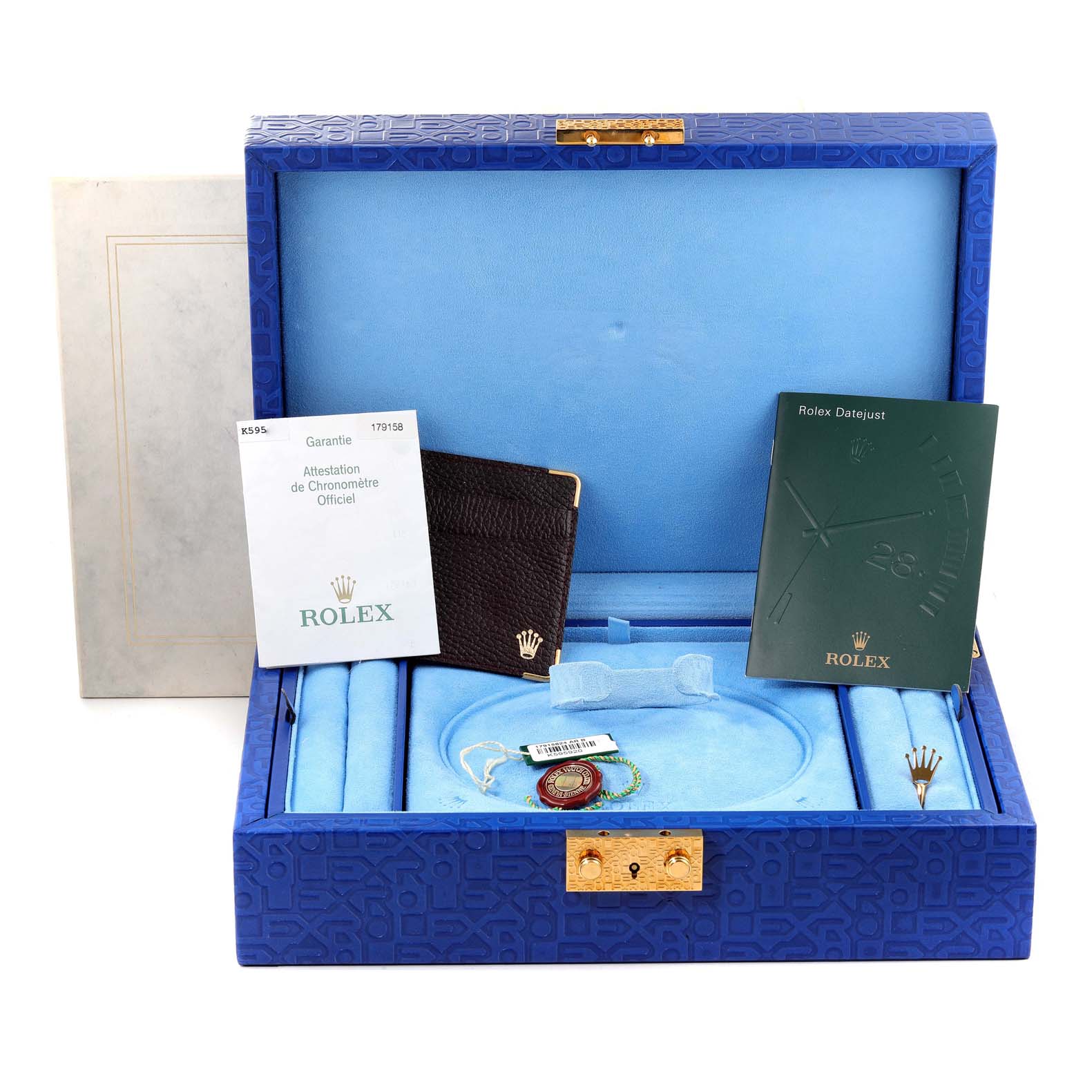 The image shows an open Rolex box for a President model, displaying documents, tags, and a leather cardholder.