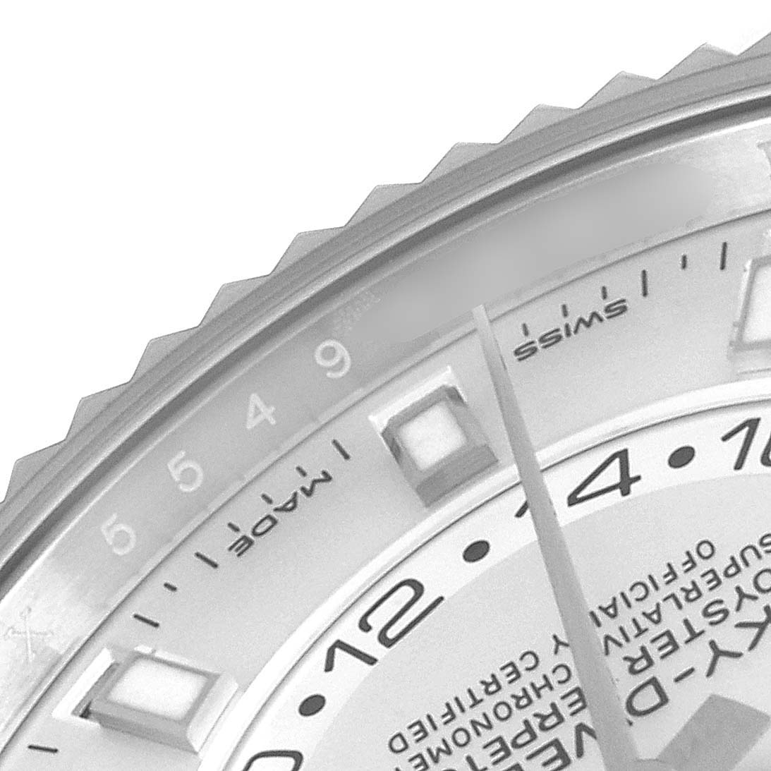 This close-up shows the bezel, dial, and part of the hands of the Rolex Sky-Dweller 326934 Men's Stainless Steel White Dial 326934 Men's Stainless Steel White Dial watch.