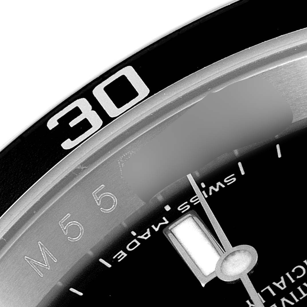 This close-up image of a Rolex Submariner 16610 Men
s Stainless Steel Black Dial 16610 Men
s Stainless Steel Black Dial watch shows part of the bezel, with the "30" marker, and portions of the dial with "Swiss made."
