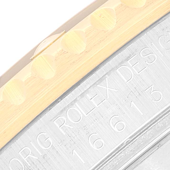 The image shows a close-up angle of the side details on the bezel and case of a Rolex Submariner 16613 Men's Steel and Gold (two tone) Blue Dial 16613 Men's Steel and Gold (two tone) Blue Dial model watch.