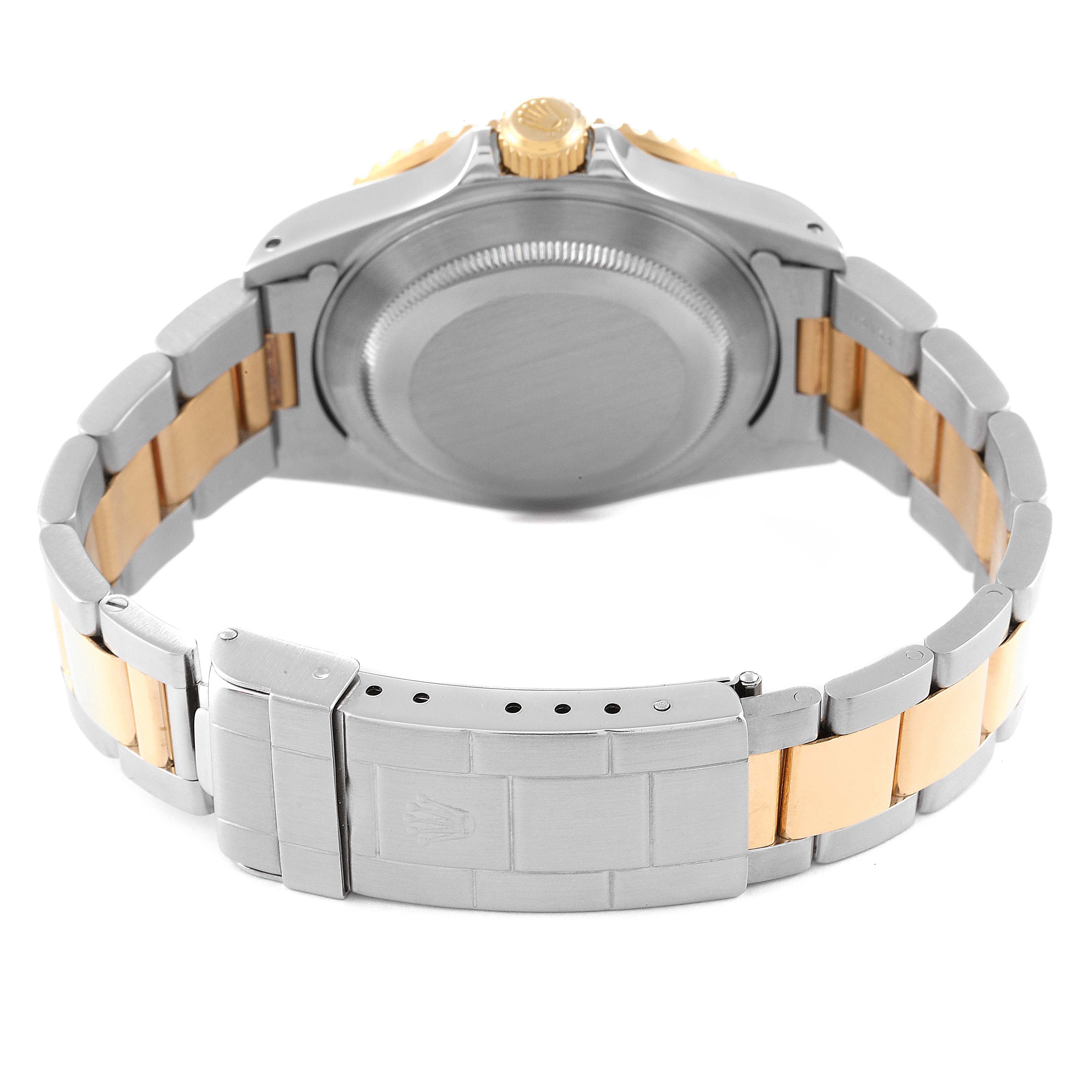 This image shows the back of a Rolex Submariner 16613 Men's Steel and Gold (two tone) Blue Dial 16613 Men's Steel and Gold (two tone) Blue Dial watch, highlighting its closed clasp and bracelet.