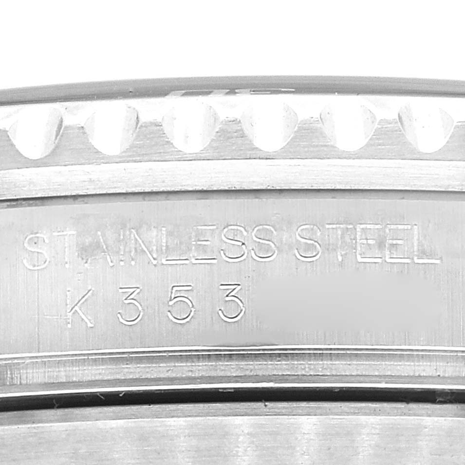 The image shows a close-up of the case back and bezel edge of a Rolex Submariner 16610 Men
s Stainless Steel Black Dial 16610 Men
s Stainless Steel Black Dial watch, highlighting its stainless steel material and serial number.